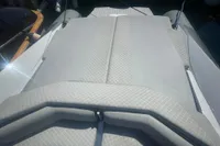 2008 SACS Strider boat with gray cushioned seating, featuring a sleek design.