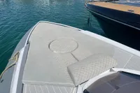 SACS Strider 2008 boat with cushioned deck, docked on calm water.