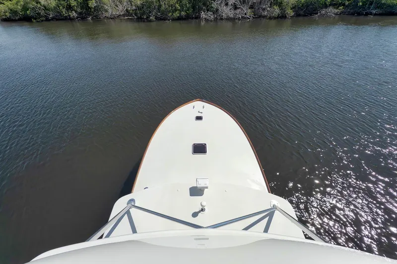 Sparkle Plenty Yacht Photos Pics Bow view of 2009 Gamefisherman Express boat on calm water near shoreline.