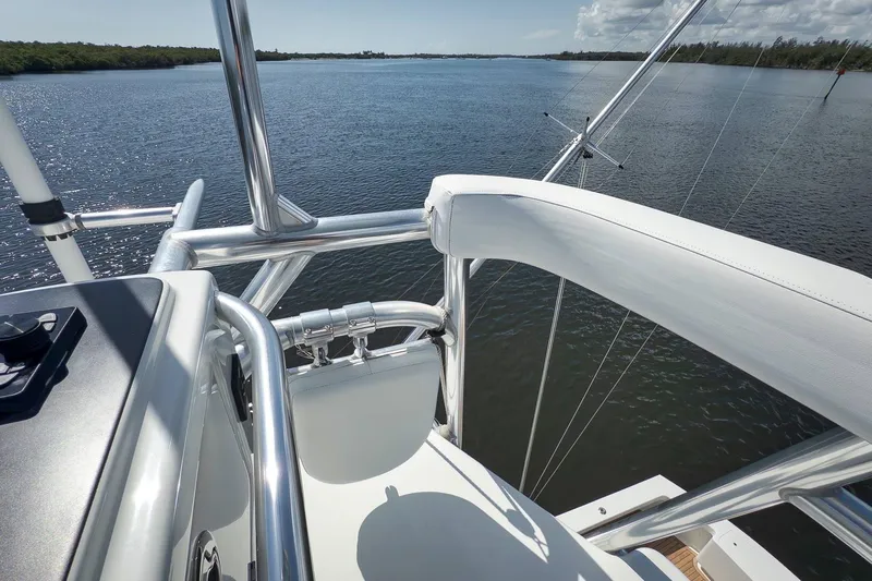 Sparkle Plenty Yacht Photos Pics 2009 Gamefisherman Express boat with sleek railing, overlooking calm waters.