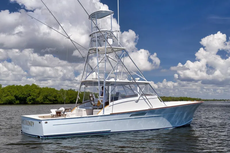 Sparkle Plenty Yacht Photos Pics 2009 Gamefisherman Express boat on water under blue sky with clouds.