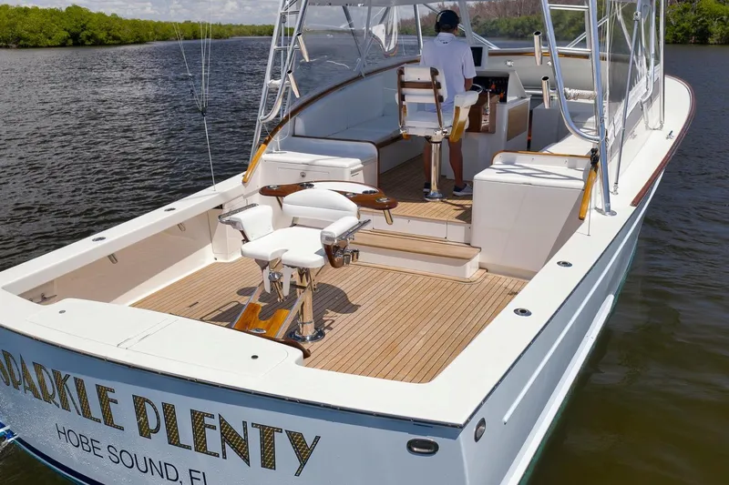 Sparkle Plenty Yacht Photos Pics 2009 Gamefisherman Express boat with spacious deck and fishing chairs on calm water.