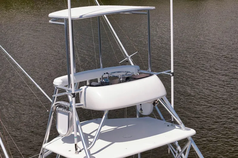 Sparkle Plenty Yacht Photos Pics 2009 Gamefisherman Express boat tower with steering wheel, on calm water.