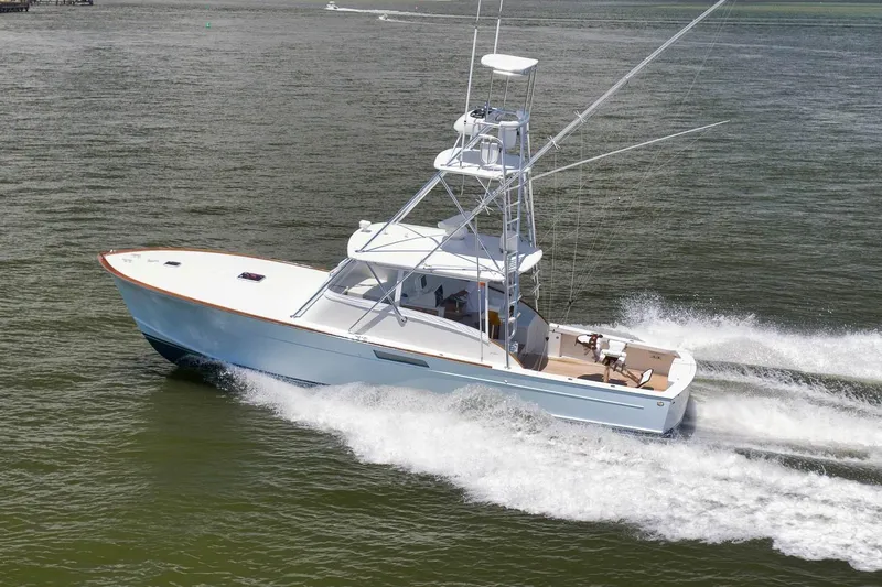 Sparkle Plenty Yacht Photos Pics 2009 Gamefisherman Express boat cruising on open water at high speed.