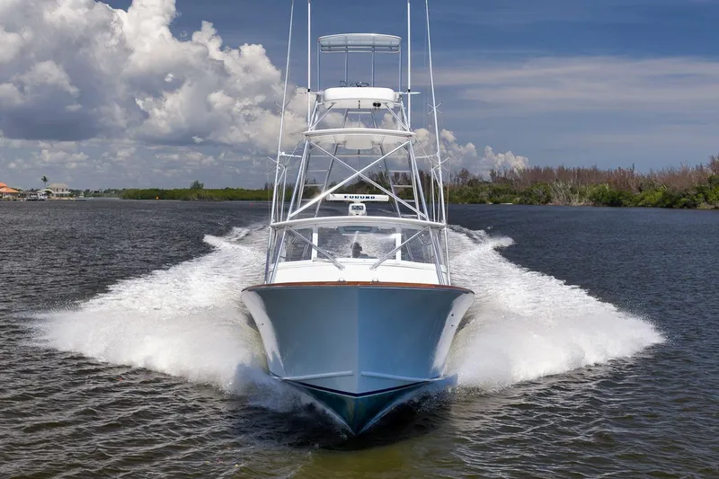 Sparkle Plenty Yacht Photos Pics 2009 Gamefisherman Express boat cruising on water under a cloudy sky.