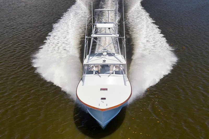 Sparkle Plenty Yacht Photos Pics 2009 Gamefisherman Express boat cruising on water, creating a dynamic wake.