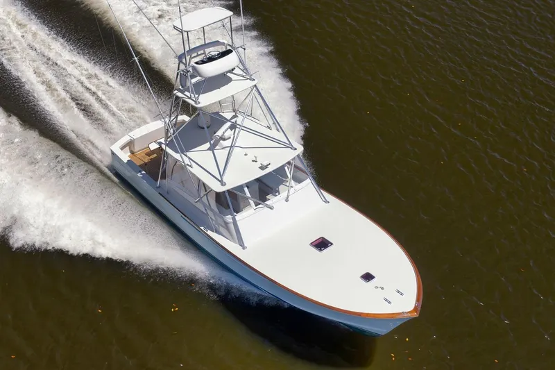 Sparkle Plenty Yacht Photos Pics 2009 Gamefisherman Express boat cruising on water, aerial view.