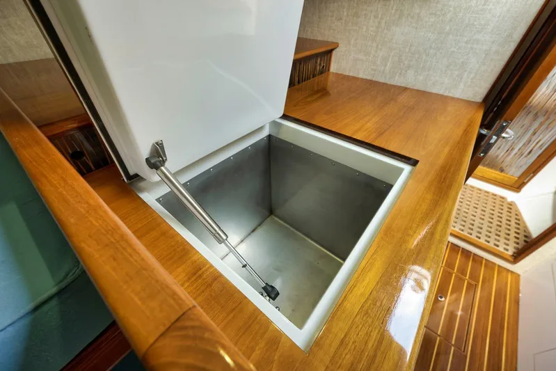 Sparkle Plenty Yacht Photos Pics 2009 Gamefisherman Express boat interior with open storage compartment and wooden finish.