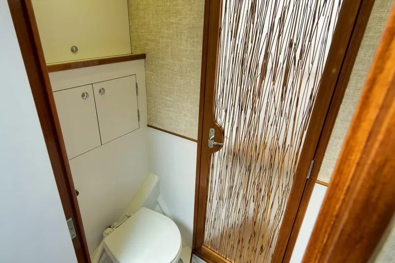 Sparkle Plenty Yacht Photos Pics 2009 Gamefisherman Express boat bathroom with wooden door and compact design.