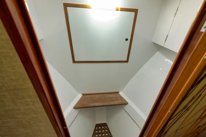 Sparkle Plenty Yacht Photos Pics 2009 Gamefisherman Express interior with wooden accents and a mirror.