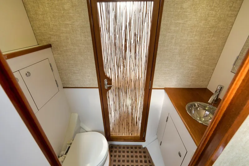 Sparkle Plenty Yacht Photos Pics 2009 Gamefisherman Express bathroom with modern sink, toilet, and decorative door.