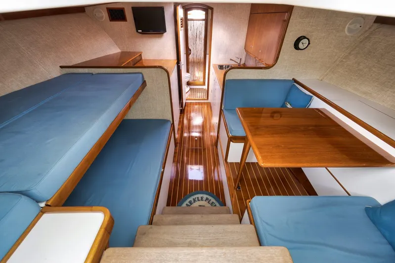 Sparkle Plenty Yacht Photos Pics 2009 Gamefisherman Express interior with blue seating, wooden table, and compact design.