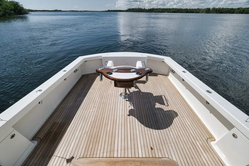 Sparkle Plenty Yacht Photos Pics 2009 Gamefisherman Express boat deck with fishing chair, surrounded by calm waters.