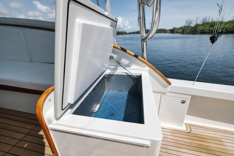 Sparkle Plenty Yacht Photos Pics 2009 Gamefisherman Express boat with open storage compartment on deck, near calm waters.