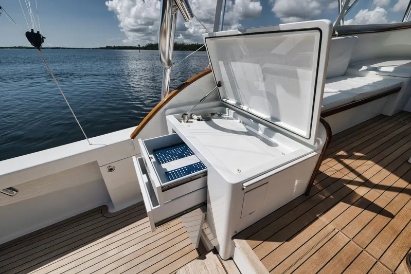 Sparkle Plenty Yacht Photos Pics 2009 Gamefisherman Express boat deck with open storage, wooden flooring, and scenic water view.