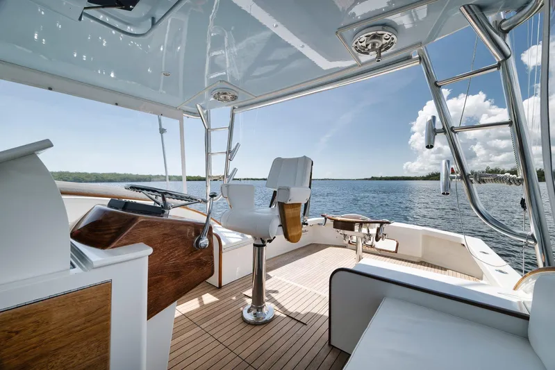 Sparkle Plenty Yacht Photos Pics 2009 Gamefisherman Express boat interior with helm, overlooking serene water and clear sky.