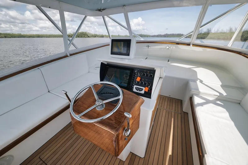 Sparkle Plenty Yacht Photos Pics 2009 Gamefisherman Express boat interior with wooden helm and modern navigation equipment.