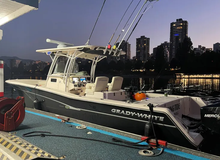  Yacht Photos Pics 2014 Grady-White Canyon 306 boat docked at night with city skyline in background.
