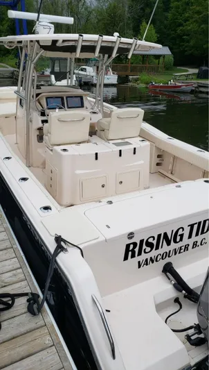  Yacht Photos Pics 2014 Grady-White Canyon 306 boat docked, featuring spacious deck and dual seating.