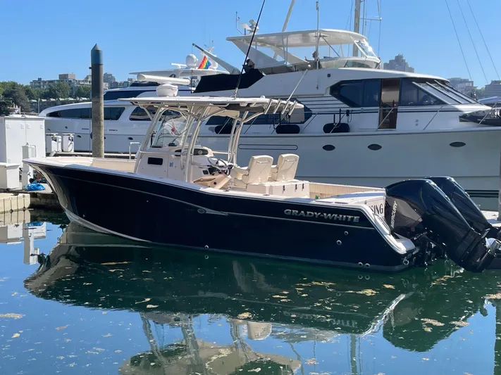  Yacht Photos Pics 2014 Grady-White Canyon 306 boat docked in marina, clear blue sky.