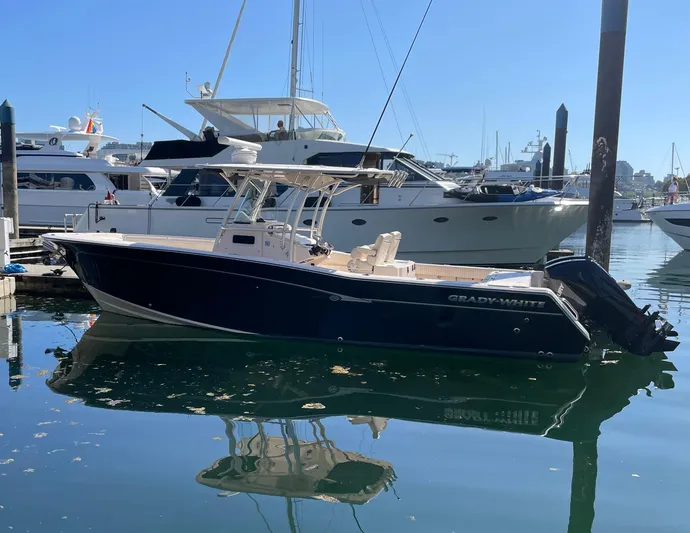  Yacht Photos Pics 2014 Grady-White Canyon 306 boat docked in a marina, surrounded by other vessels.