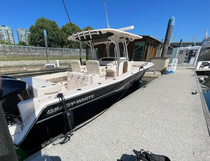  Yacht Photos Pics 2014 Grady-White Canyon 306 boat docked at marina under clear blue sky.