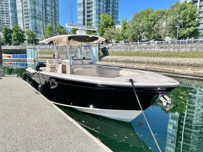  Yacht Photos Pics 2014 Grady-White Canyon 306 boat docked in urban marina with modern buildings.