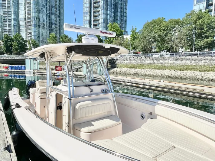  Yacht Photos Pics 2014 Grady-White Canyon 306 boat docked in urban marina with skyscrapers.