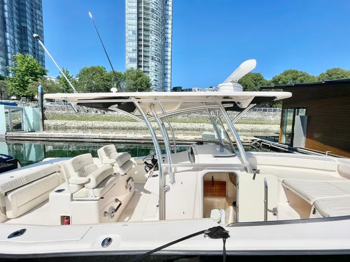  Yacht Photos Pics 2014 Grady-White Canyon 306 boat docked, featuring spacious seating and modern design.