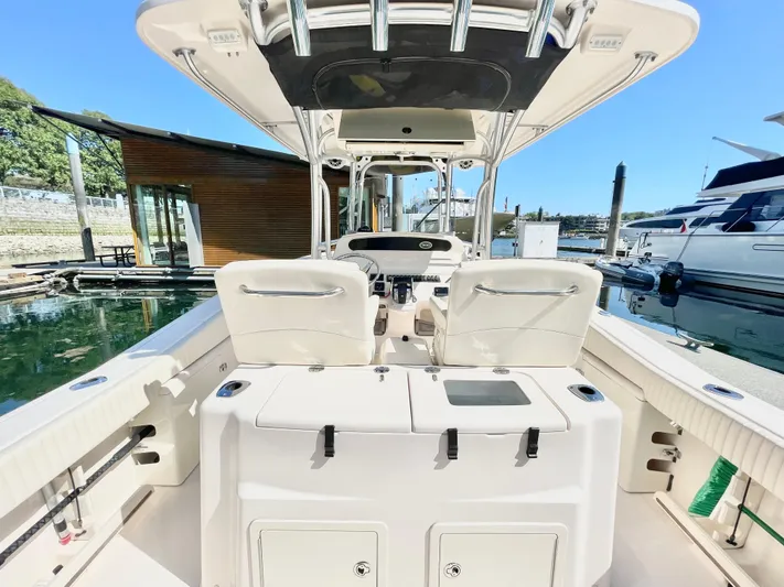  Yacht Photos Pics 2014 Grady-White Canyon 306 boat interior at marina, showcasing seating and helm.
