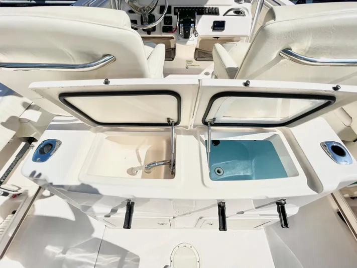  Yacht Photos Pics 2014 Grady-White Canyon 306 boat interior with open storage compartments and seating.