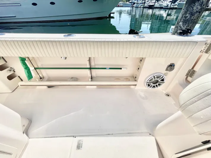  Yacht Photos Pics 2014 Grady-White Canyon 306 boat interior with seating and speaker, docked at marina.