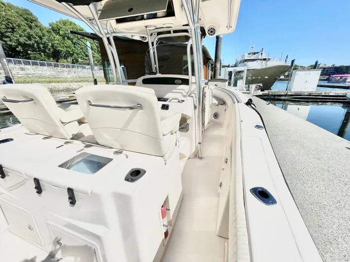  Yacht Photos Pics 2014 Grady-White Canyon 306 boat interior at dock, featuring seating and helm station.