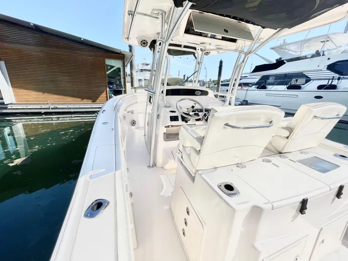  Yacht Photos Pics 2014 Grady-White Canyon 306 boat docked, featuring sleek design and spacious seating.