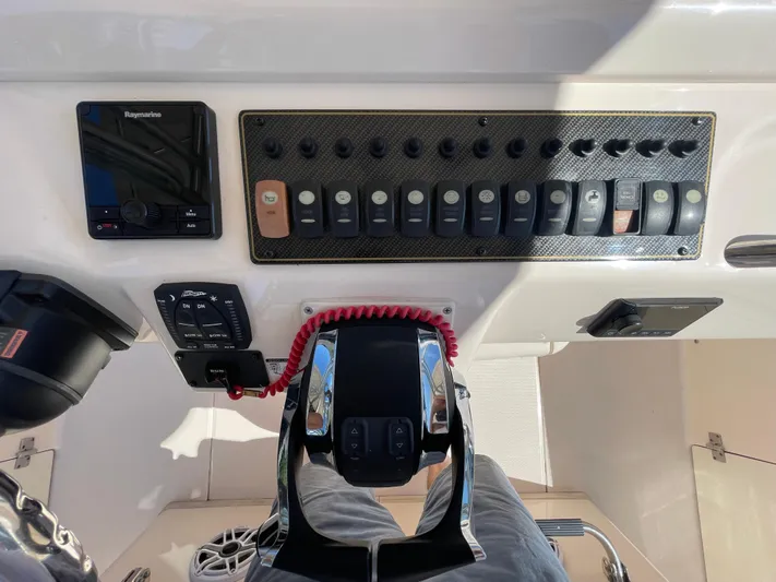  Yacht Photos Pics Control panel of a 2014 Grady-White Canyon 306 boat with switches and throttle.