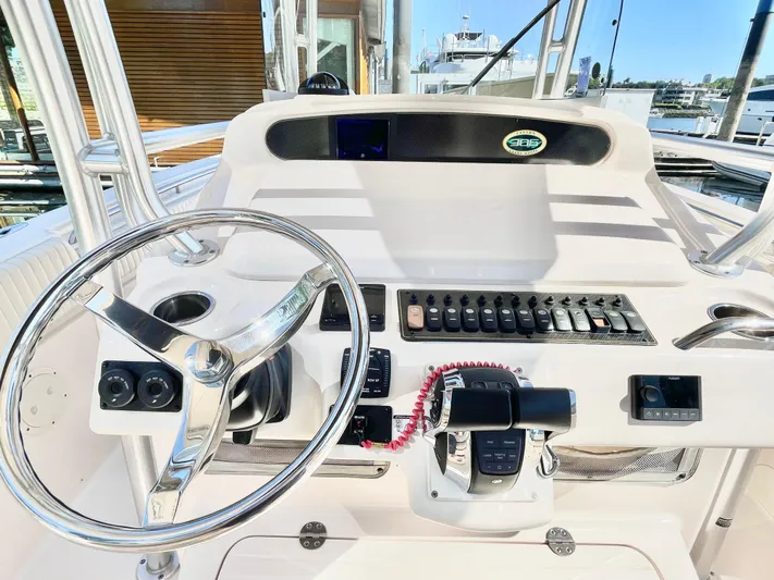  Yacht Photos Pics 2014 Grady-White Canyon 306 boat dashboard with steering wheel and control panel.