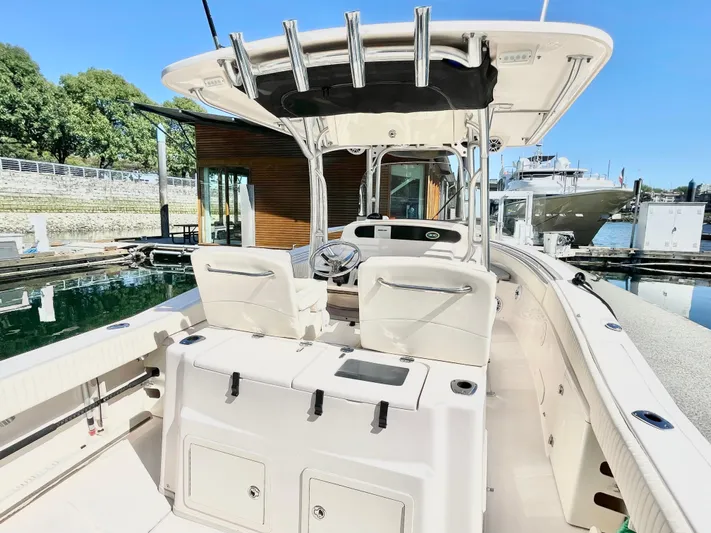  Yacht Photos Pics 2014 Grady-White Canyon 306 boat interior at marina, featuring helm and seating.