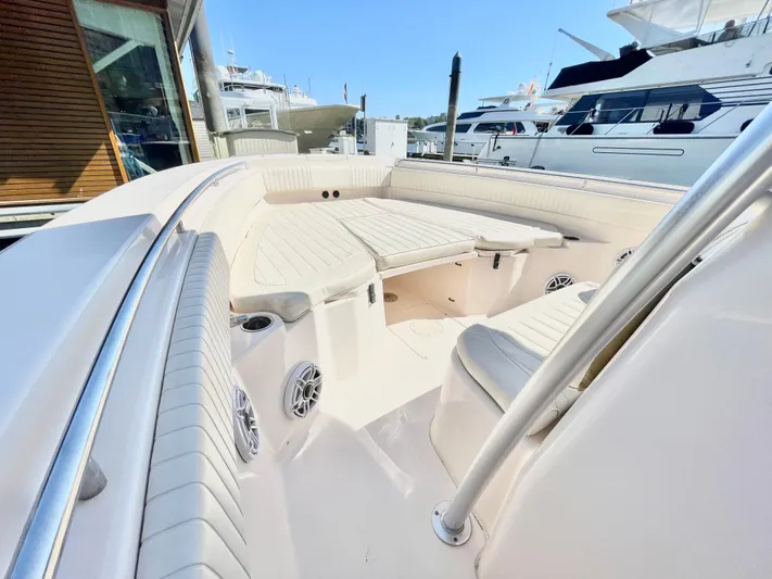  Yacht Photos Pics 2014 Grady-White Canyon 306 boat interior with seating and speakers at a marina.