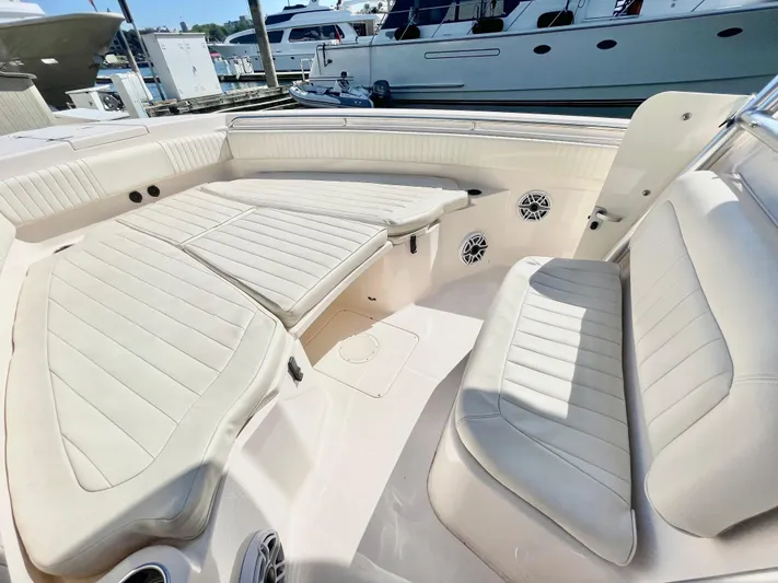  Yacht Photos Pics 2014 Grady-White Canyon 306 boat interior with cushioned seating and speakers.