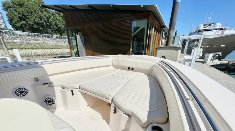  Yacht Photos Pics 2014 Grady-White Canyon 306 boat interior with cushioned seating at a dock.