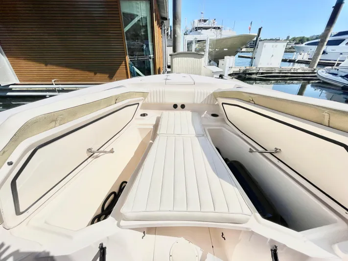  Yacht Photos Pics 2014 Grady-White Canyon 306 boat interior with open storage compartments at a marina.