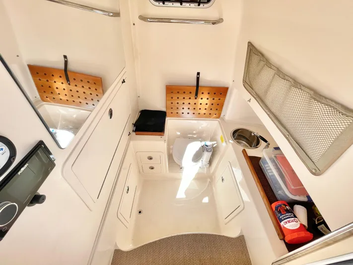  Yacht Photos Pics 2014 Grady-White Canyon 306 cabin interior with storage and amenities.