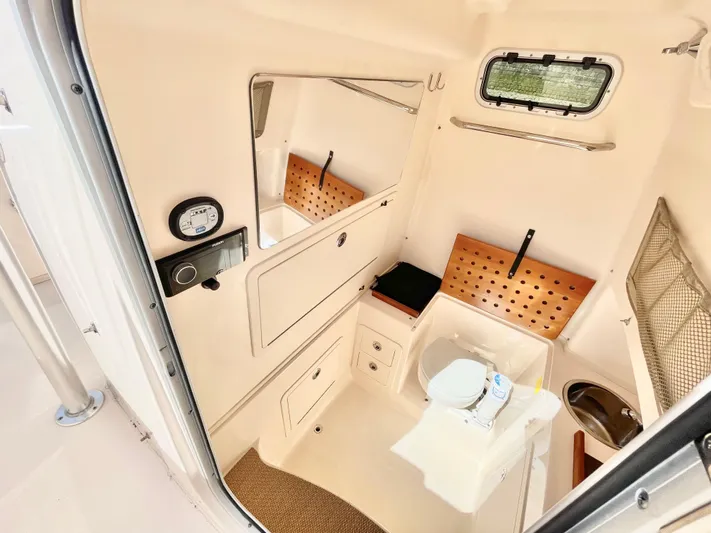  Yacht Photos Pics 2014 Grady-White Canyon 306 boat interior with compact bathroom and storage features.