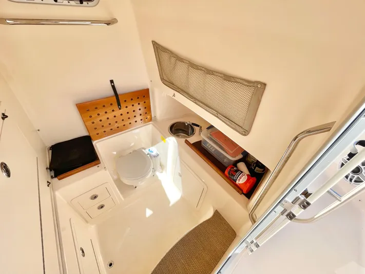  Yacht Photos Pics 2014 Grady-White Canyon 306 boat interior with compact bathroom amenities.