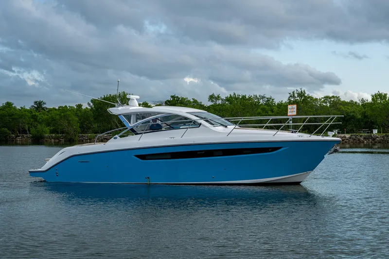  Yacht Photos Pics 2018 Pursuit SC 365i Sport Coupe yacht on calm water, under cloudy sky.