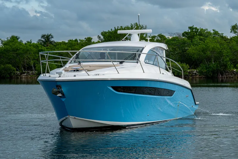  Yacht Photos Pics 2018 Pursuit SC 365i Sport Coupe cruising on a serene waterway.