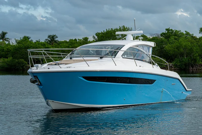  Yacht Photos Pics 2018 Pursuit SC 365i Sport Coupe cruising on a calm waterway.