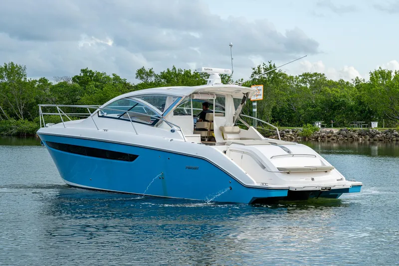  Yacht Photos Pics 2018 Pursuit SC 365i Sport Coupe cruising on a calm waterway.
