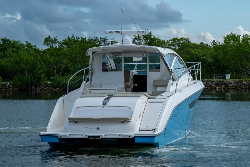 Yacht Photos Pics 2018 Pursuit SC 365i Sport Coupe cruising on a calm waterway.