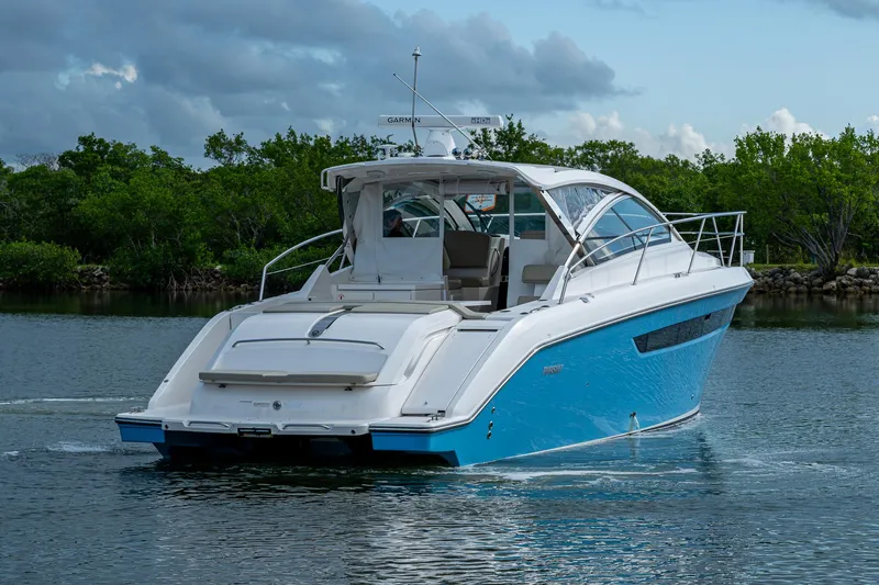  Yacht Photos Pics 2018 Pursuit SC 365i Sport Coupe cruising on a calm waterway.